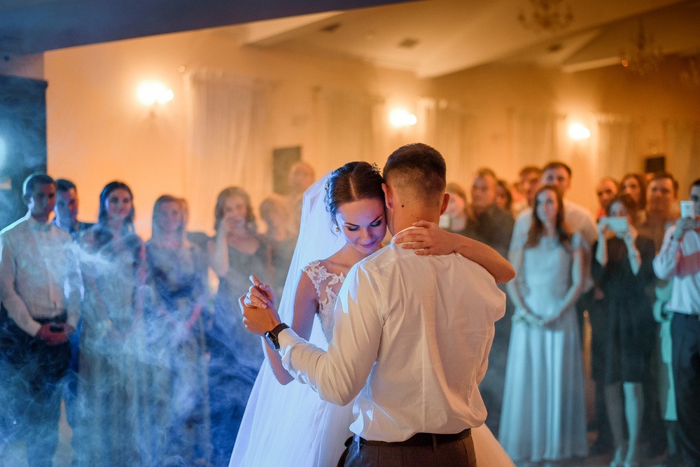 Blue,And,Yellow,Lights,Shine,Around,Wedding,Couple,Dancing,In
